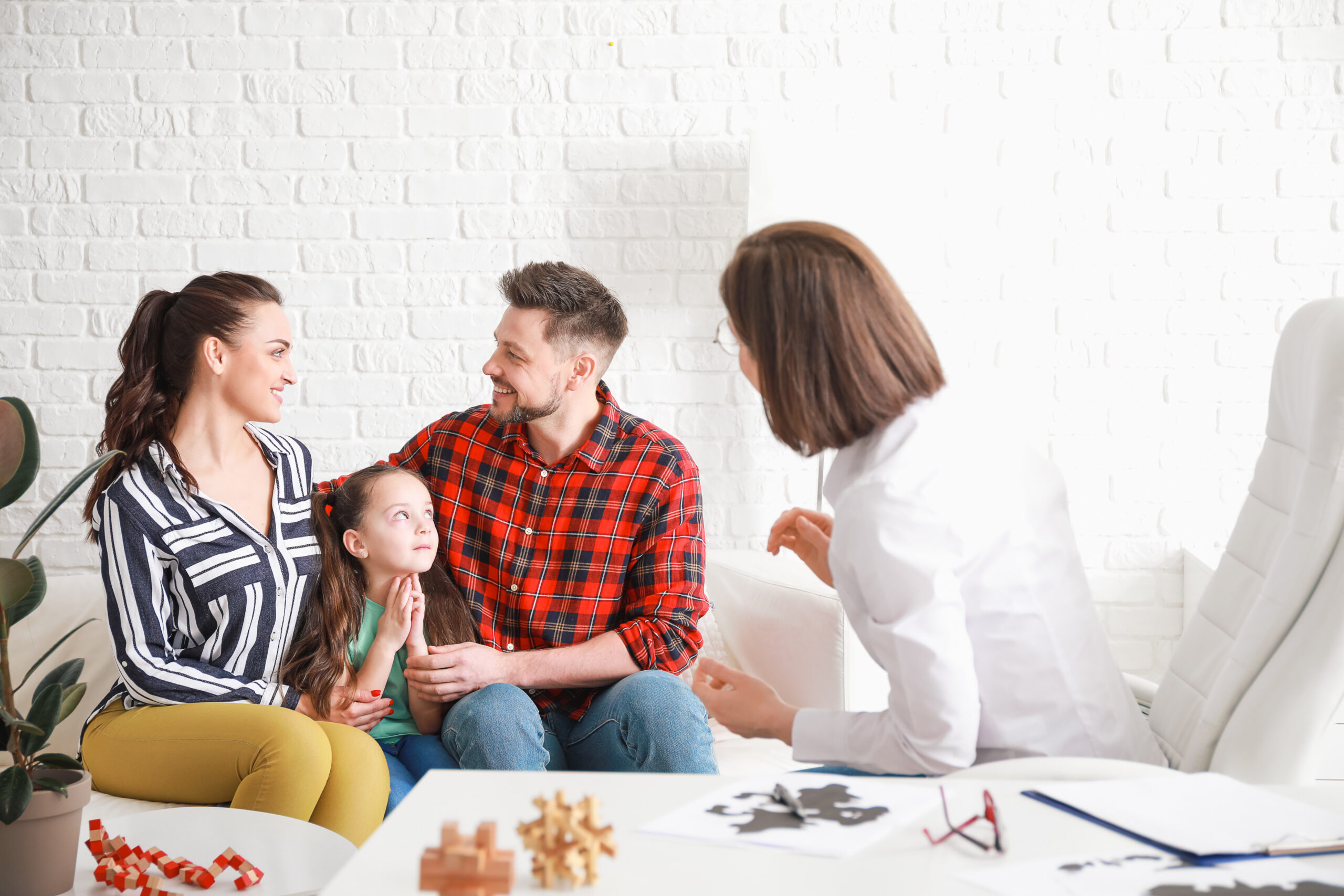 Family visiting psychologist in office